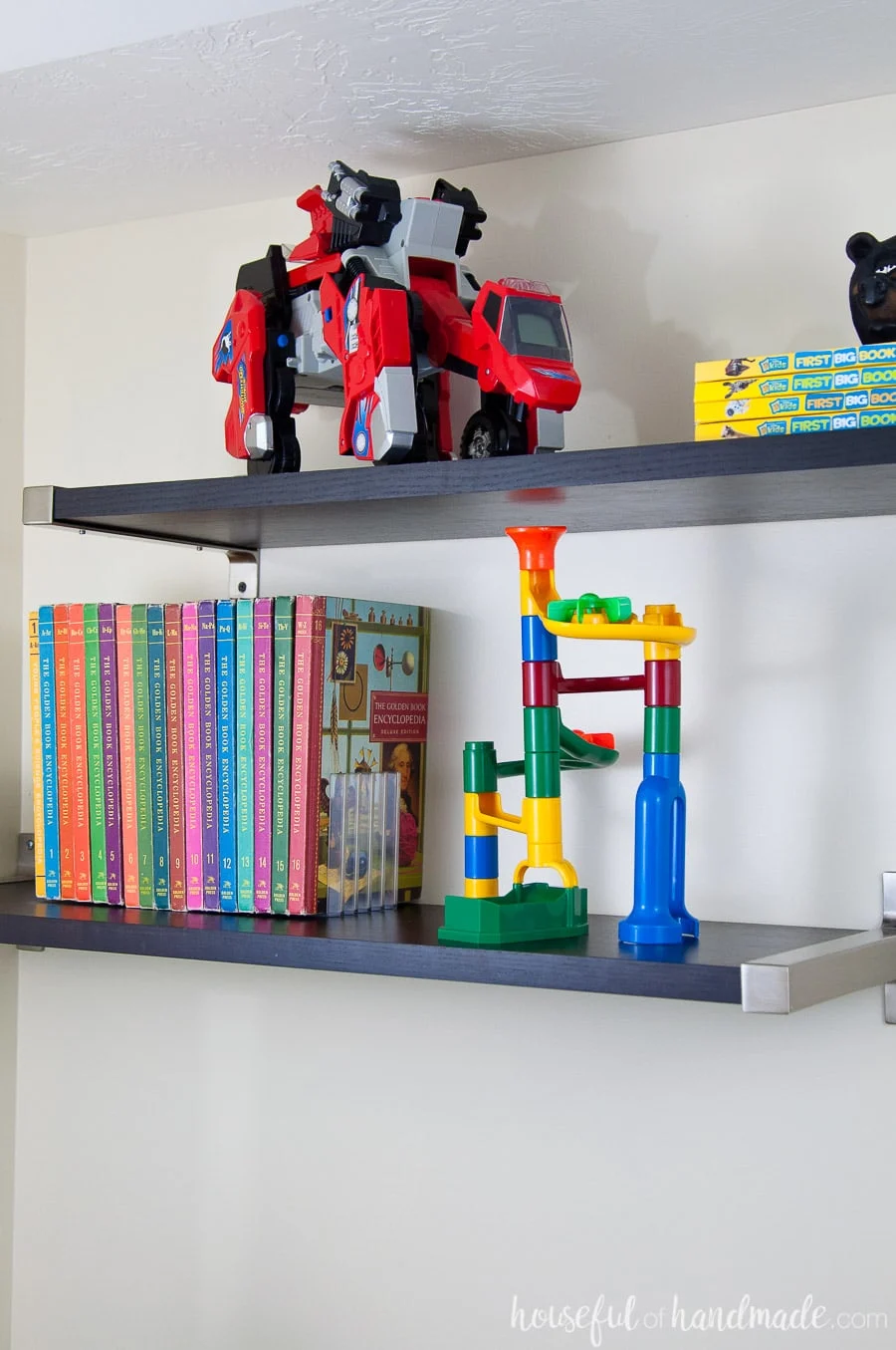 Floating wall shelves from Ikea to store books and toys in a boys bedroom. 