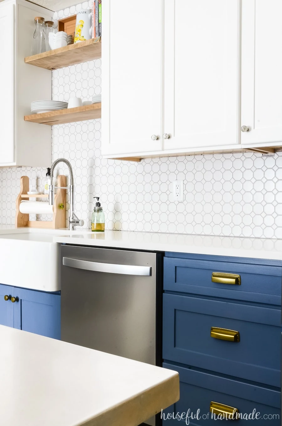 Navy base cabinets with white quartz counter top and white upper cabinets. 