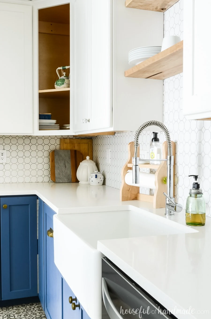 Kitchen remodel with white quartz countertops. Two tone kitchen cabinets with blue base cabinets and white upper cabinets. 