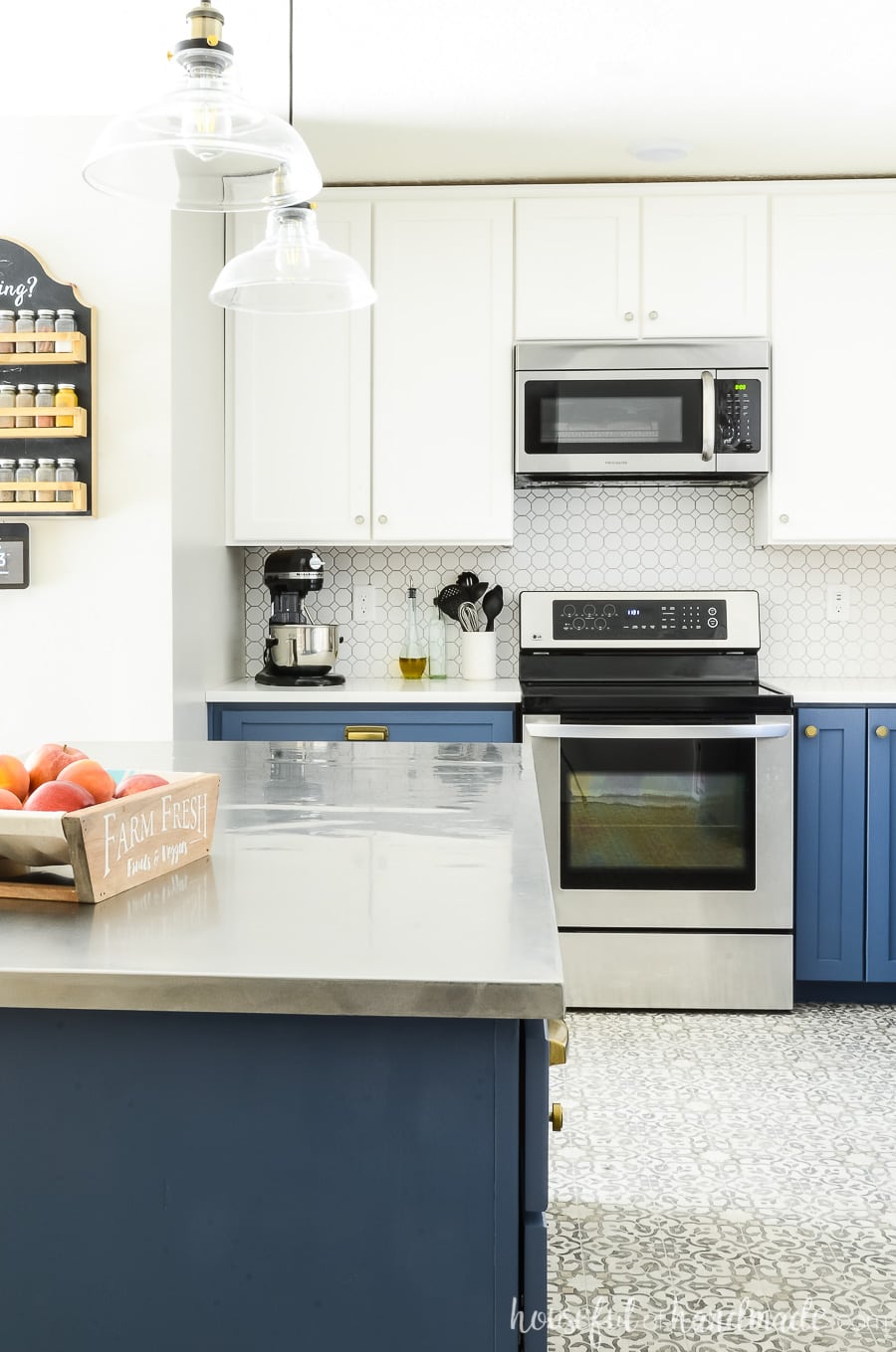 Two tone kitchen with Durango Blue lower cabinets and white upper cabinets. White octagon porcelain tile backspace and silver appliances. 