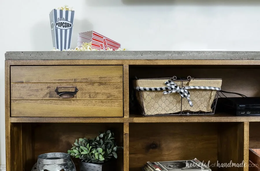 Cropped view of the rustic TV stand showing a close up of one of the 2 drawers. Routered detail on the drawer front.