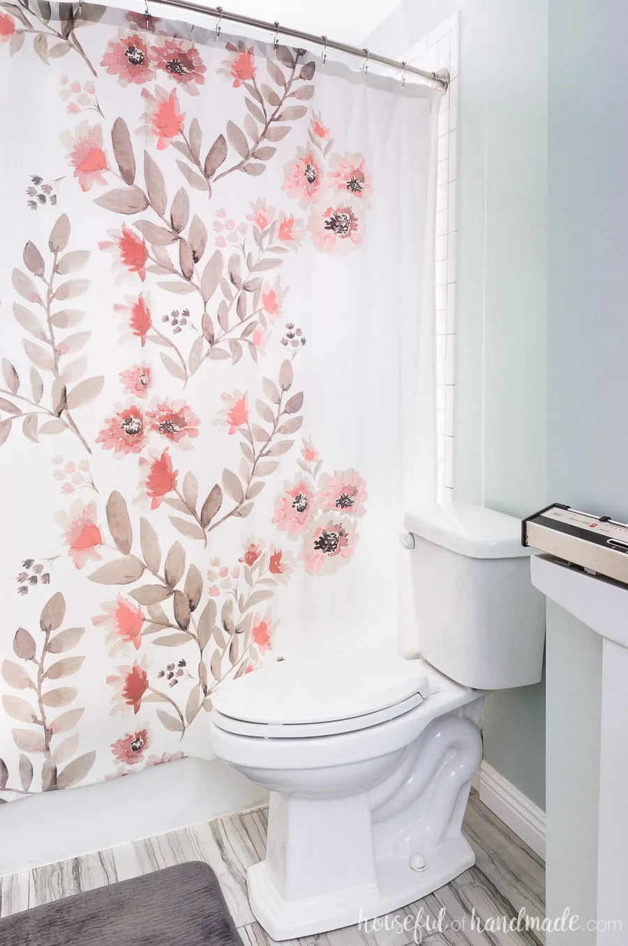 White shower curtain with coral flowers and brown leaves competes the spa-like master bathroom retreat. 