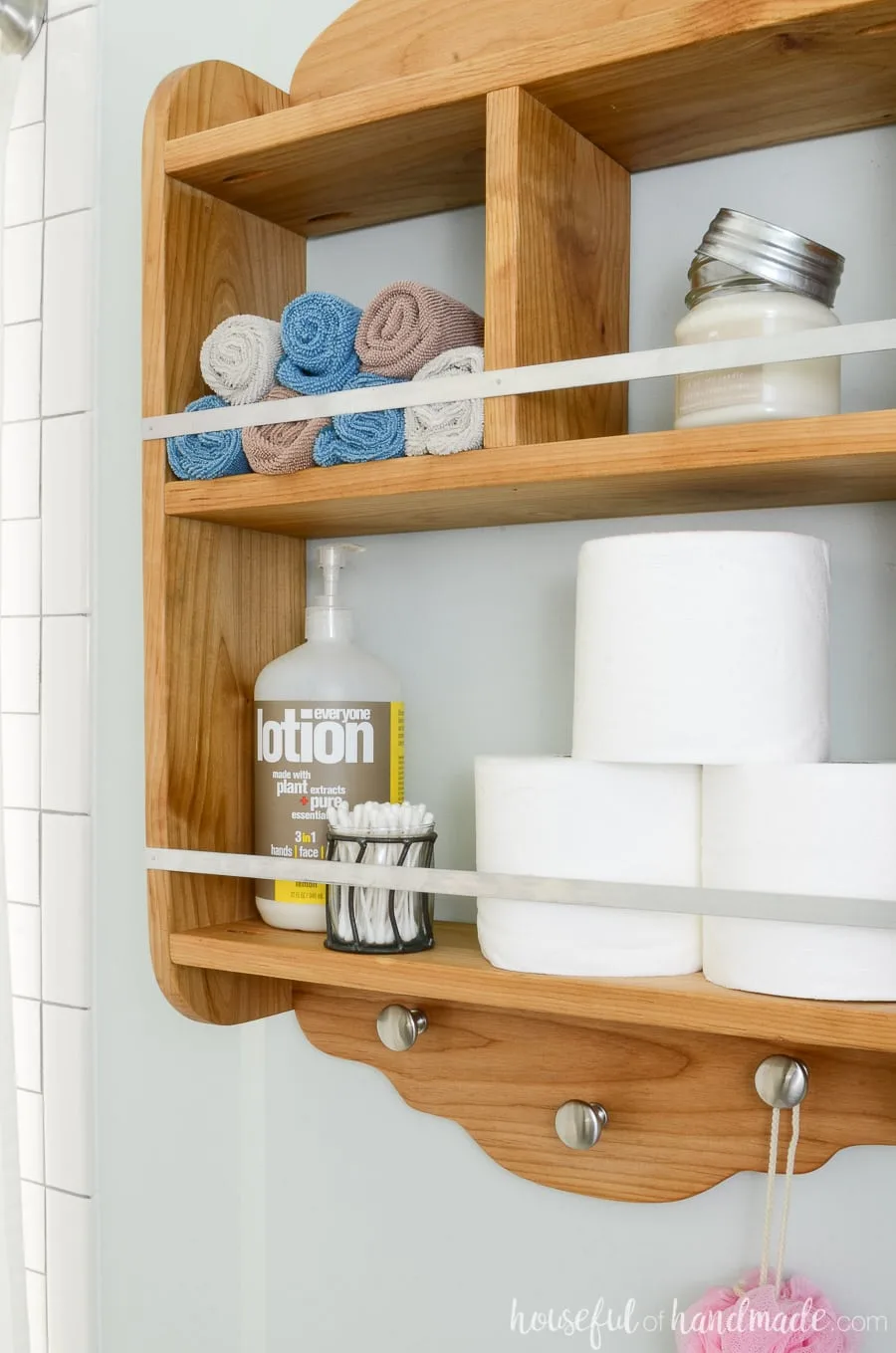 Farmhouse storage shelf in the bathroom is perfect for adding storage to a small bathroom. 