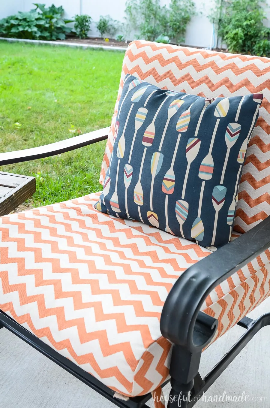 Bright colors give our outdoor living spaces an island vibe. These white and orange striped outdoor cushions are perfect with the colorful ores on a navy background pillow. 
