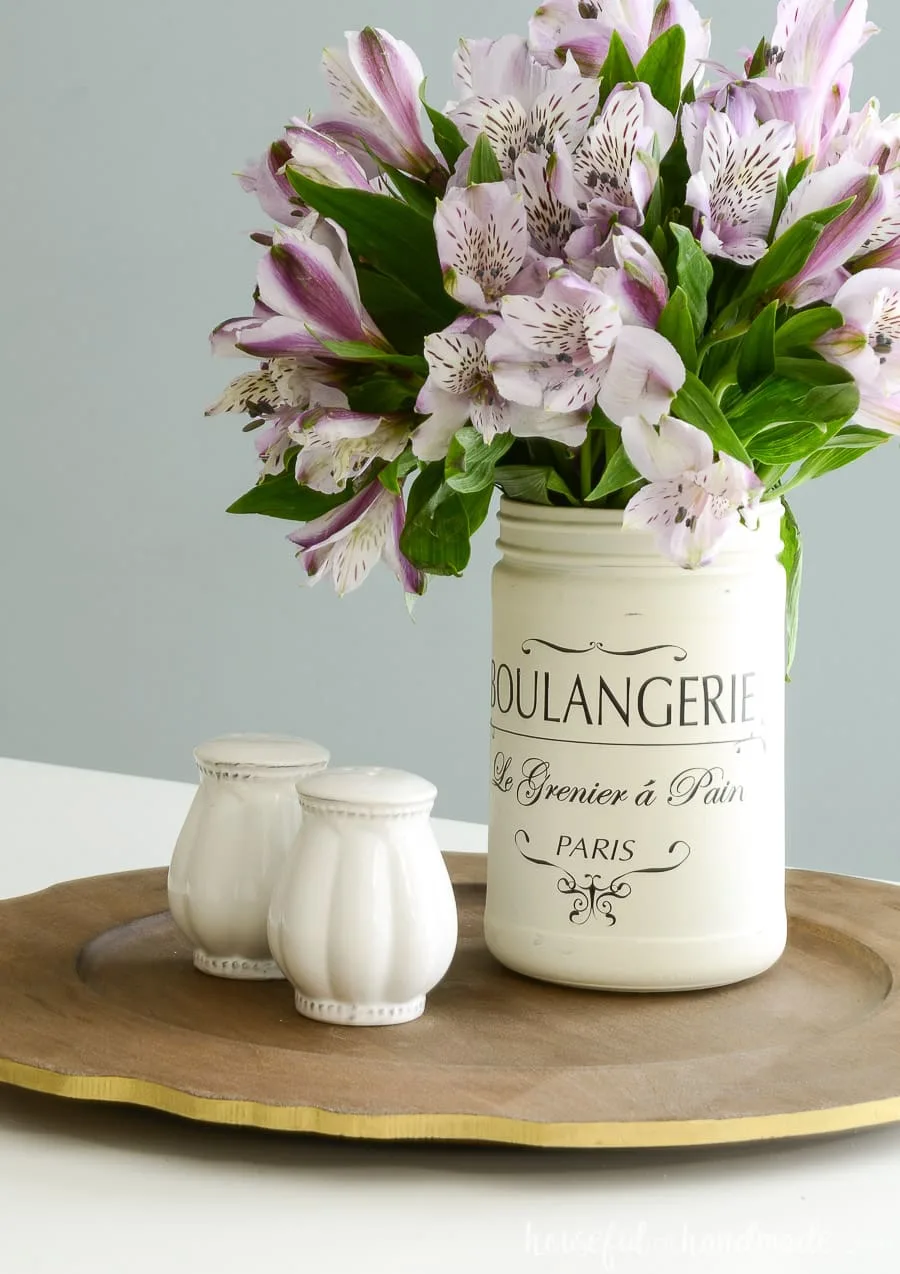 Flowers in a French canister vase on an upcycled tray with salt & pepper shakers. 