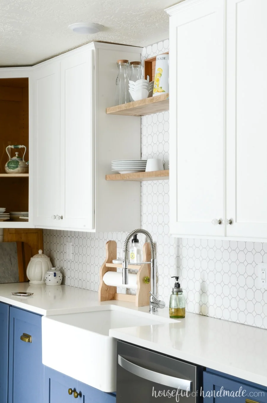 Apron front white farmhouse sink in blue & white two tone kitchen. 