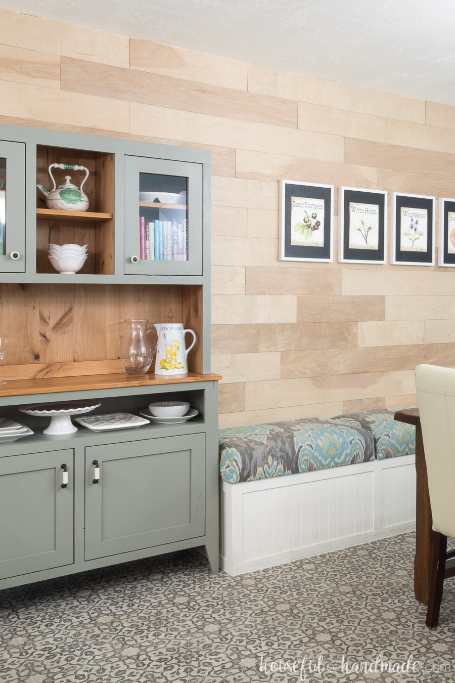 Dining room bench next to modern farmhouse hutch in the dining room. 