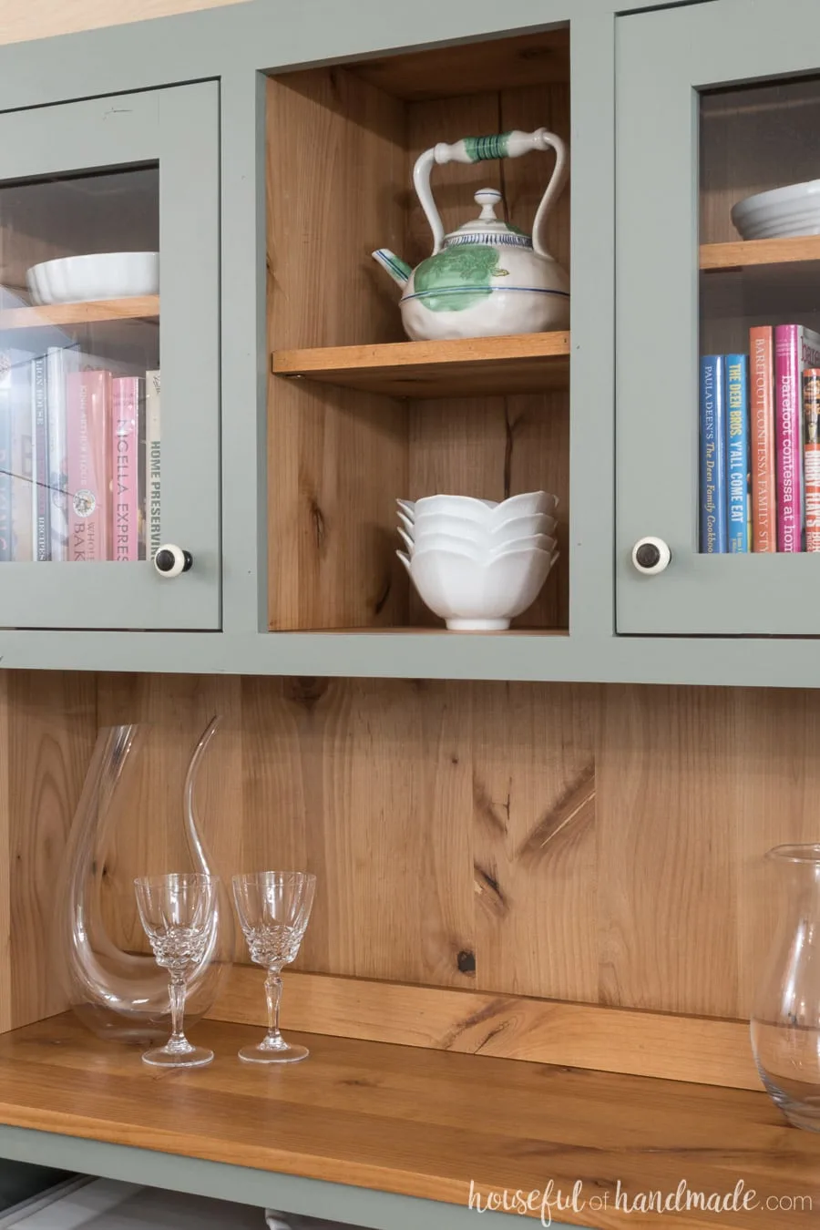 Closeup view of the natural wood with the visible knots and grain, on the inside of the dining room hutch. Outside is painted a warm gray. 