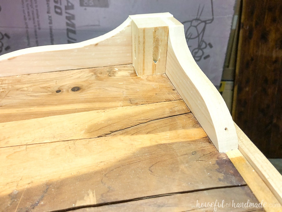 A 2x2 foot was added to the decorative feet to make the upcycled coffee table more sturdy.