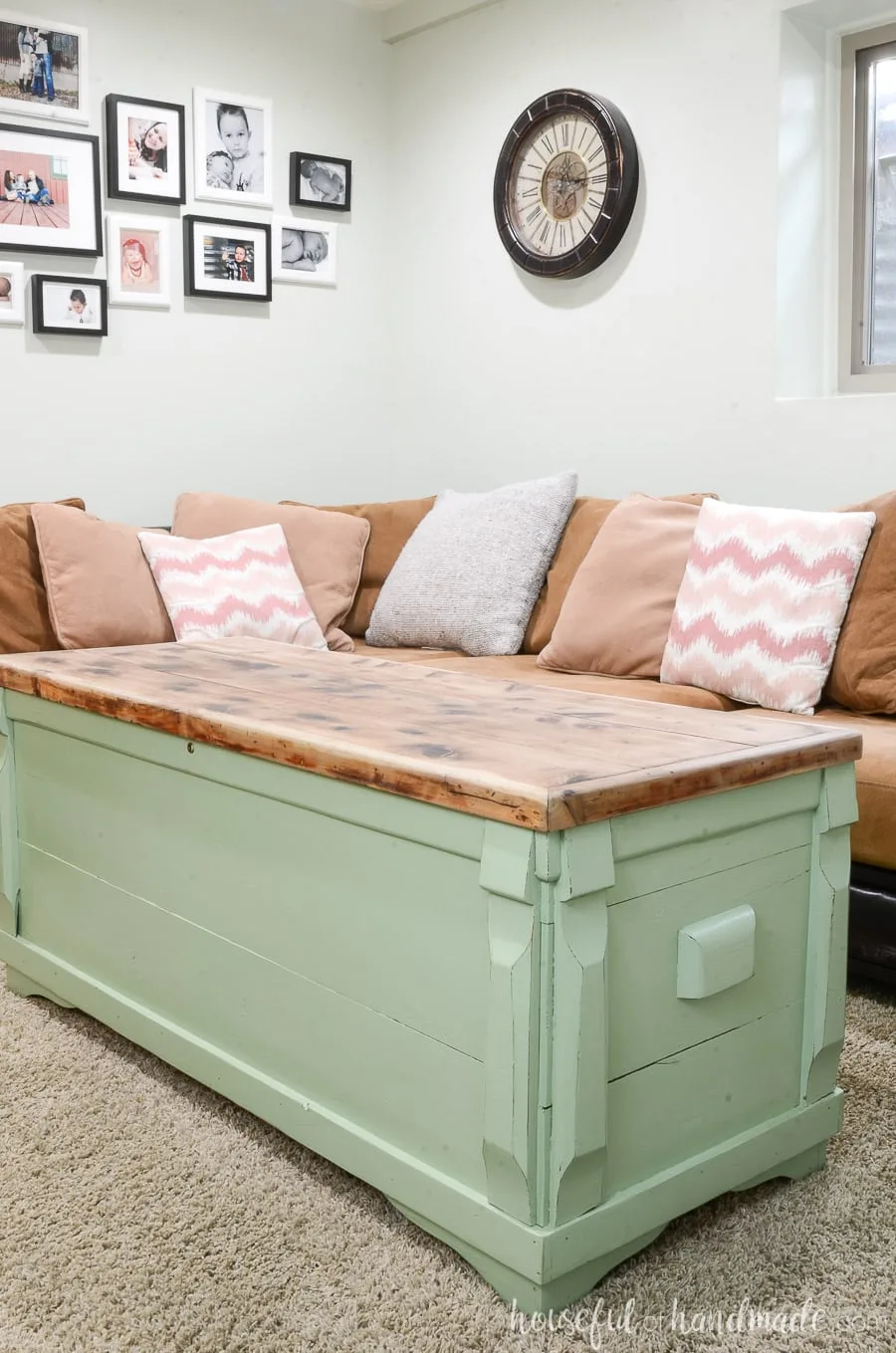Moss green painted storage chest with raw cedar wood top as a coffee table in a living room. 