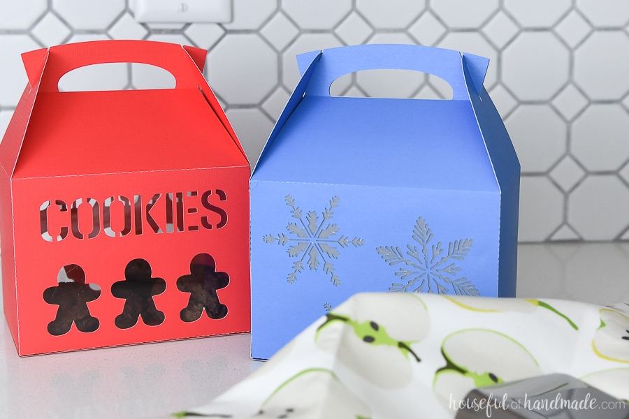 Two handmade Christmas Cookie boxes on the kitchen counter. 