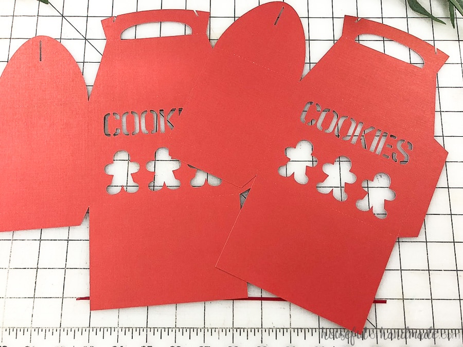 Two Christmas Cookie box templates cut out of red paper.