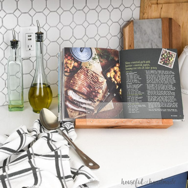 DIY cookbook stand holding a farmhouse cookbook in the kitchen.