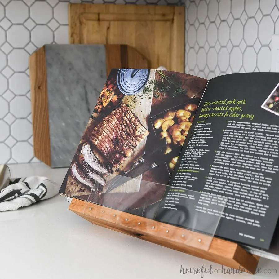 Cookbook being held open for hands-free cooking in a DIY cookbook holder. 