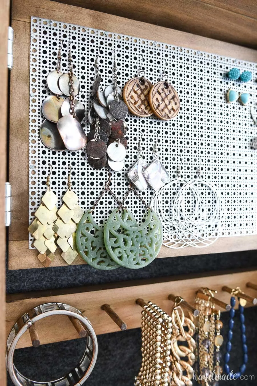 Close up of the hinged earring rack in the hidden jewelry cabinet. 