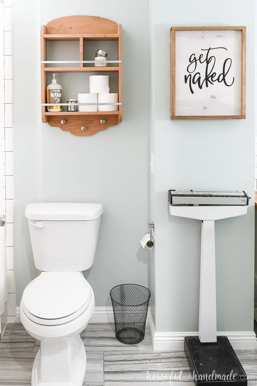 Bathroom with DIY wall jewelry organizer with a wood sign front.
