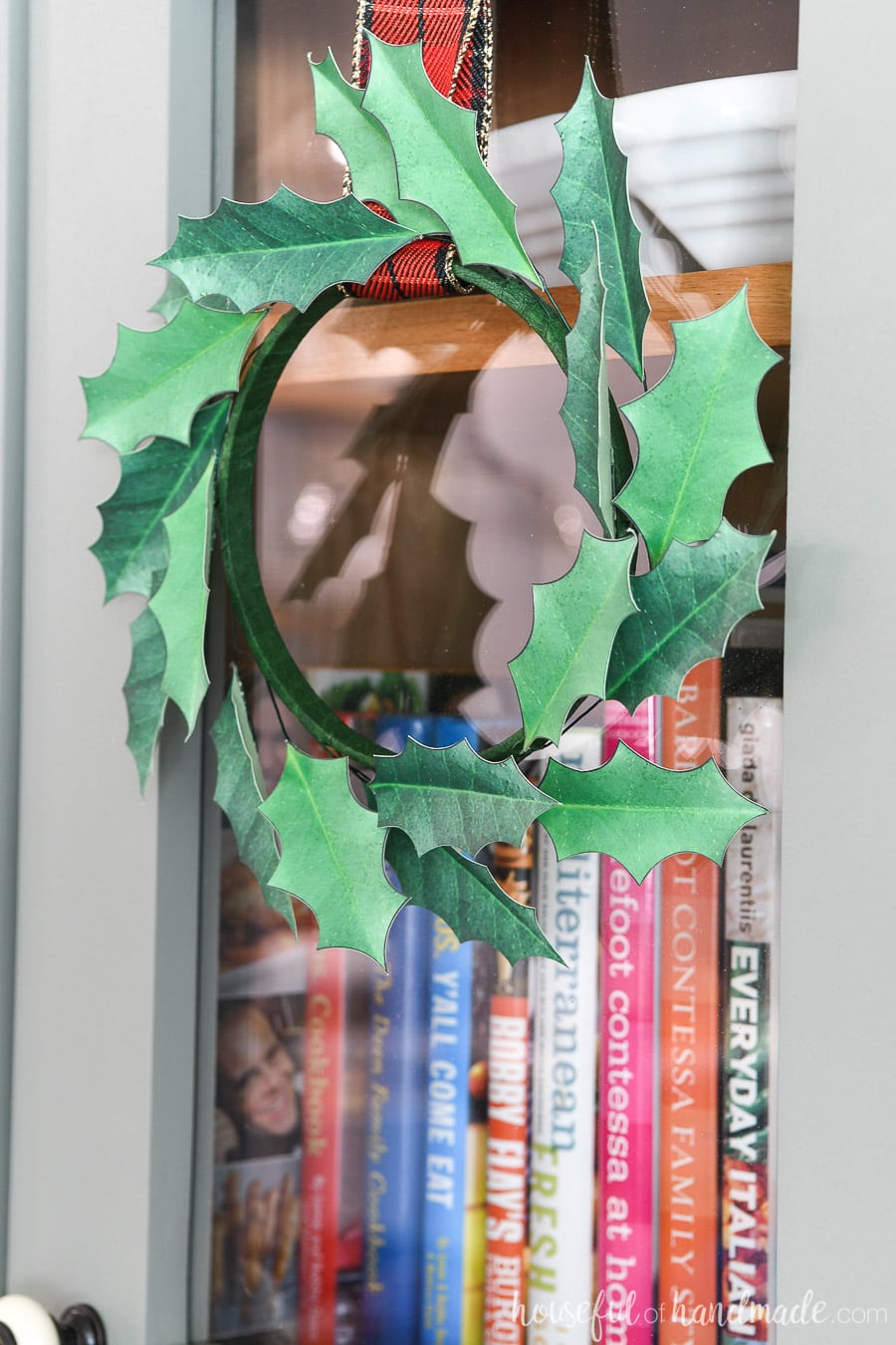 Close up of the paper Christmas wreath handing on the cabinet door. Best easy paper Christmas decor!