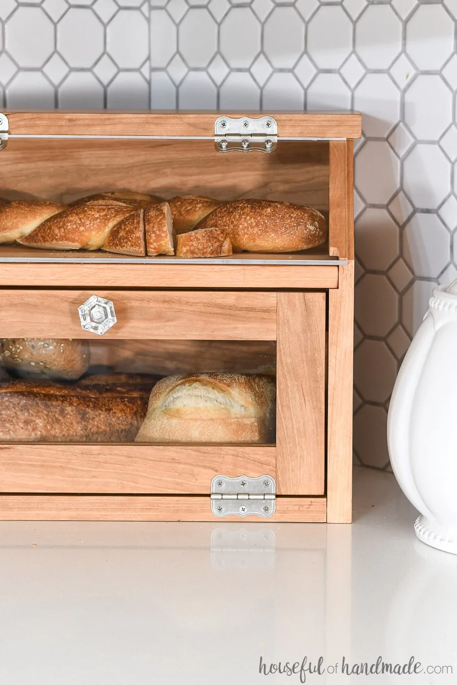 Close up view of the DIY bread box full of bread on the kitchen counter.