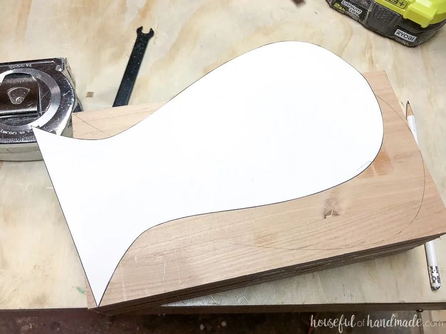Headphone stand template being traced onto the wood. 