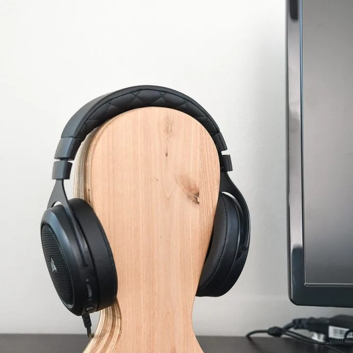 Computer desk with headphones on a DIY headphone stand.