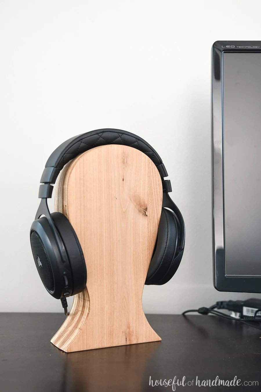 Computer desk with headphones on a DIY headphone stand. 