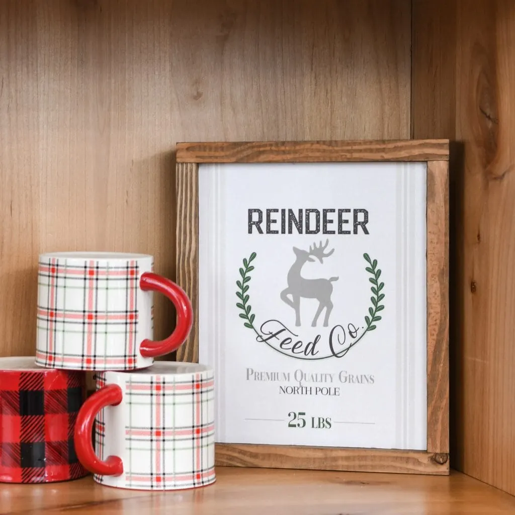 Easy DIY wood sign that says Reindeer Feed Co. on it.