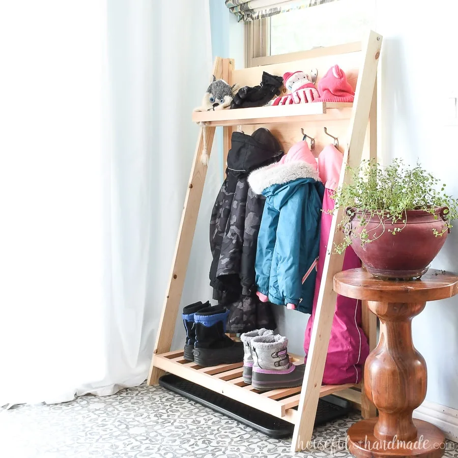 Square picture of the fold-up storage shelves holding extra seasonal gear in the mudroom.