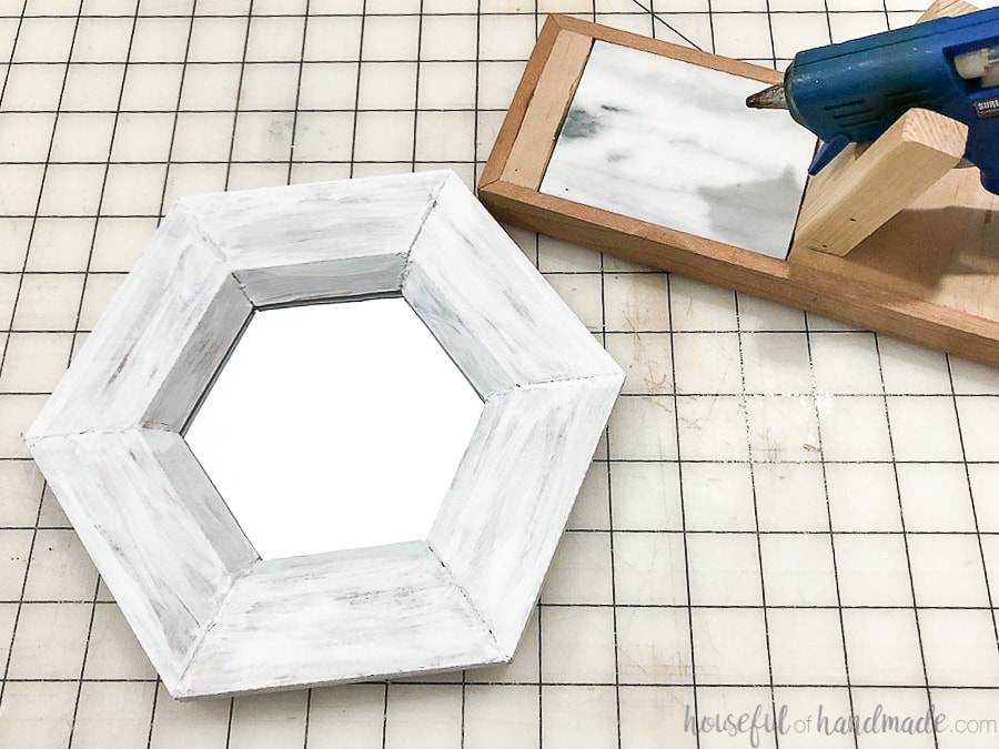 Glue the mirror into the back of your hexagon wall mirror frame.