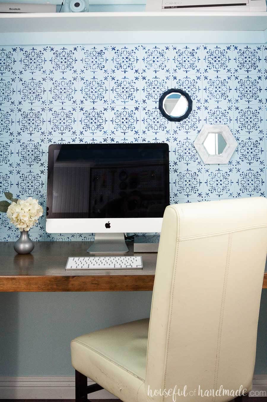 Closet desk area decorated with small wall mirrors made out of paper.