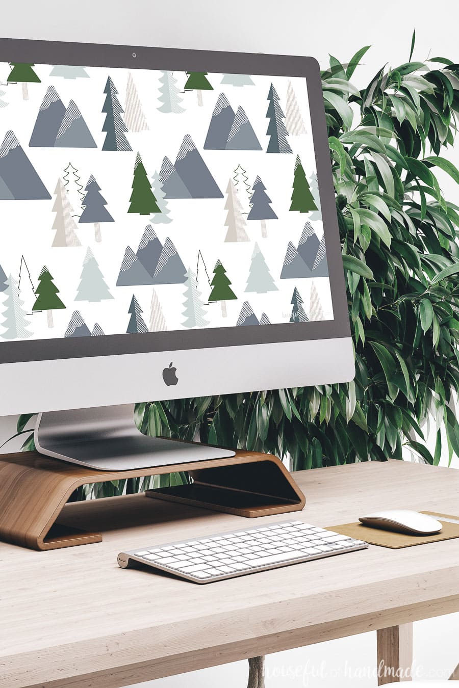 Angled view of a computer with the winter digital wallpaper on it.