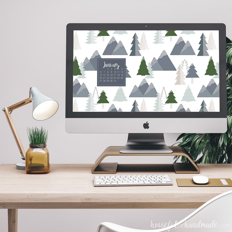Desktop computer on a desk showing the free digital backgrounds for January on the screen.
