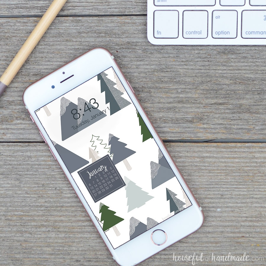 White iPhone with a winter themed digital background on the screen.