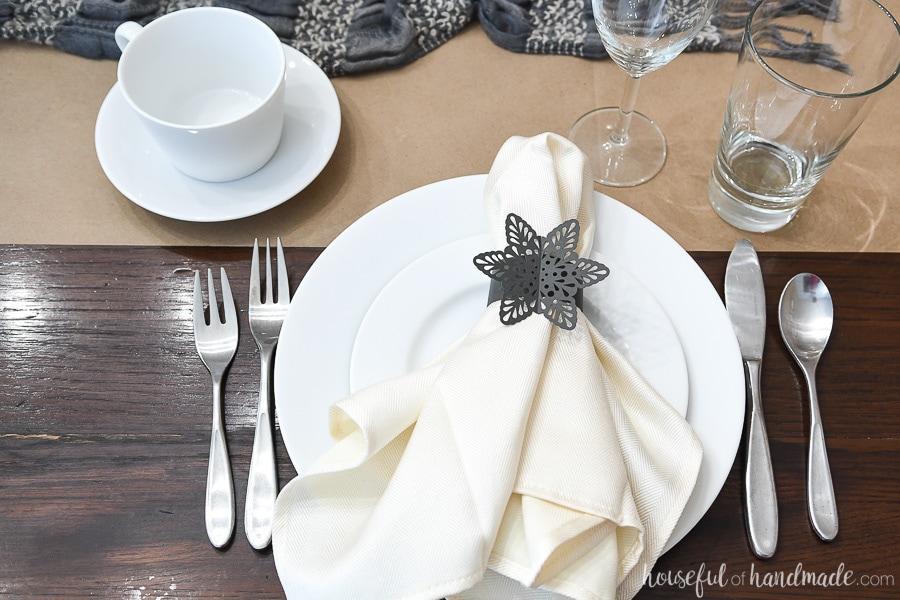 Winter table setting with paper snowflake napkin rings and mugs.