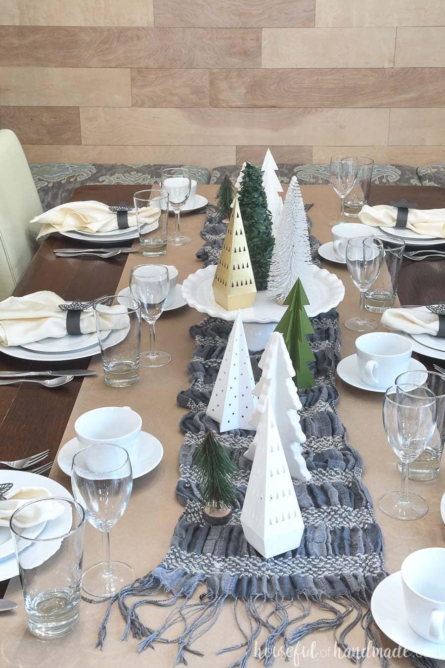 Papercraft winter tablescape with brown paper, a winter scarf, and trees made from paper.