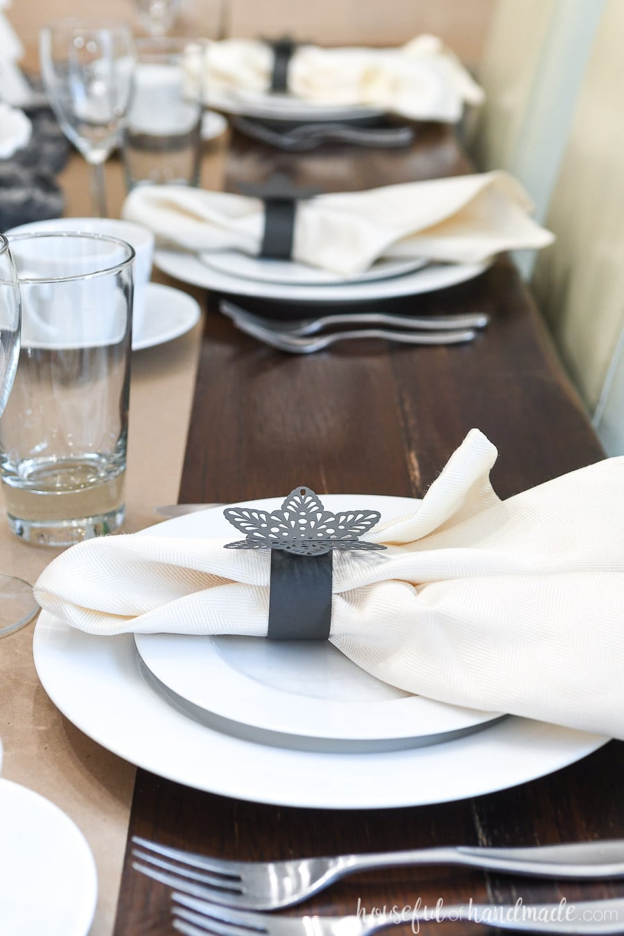 Close-up of the snowflake paper napkin rings on the papercraft winter tablescape.