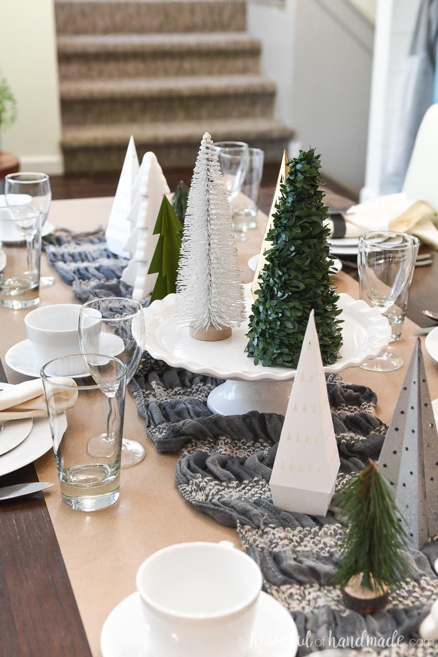 Paper Christmas trees decorating the centerpiece of a winter table.