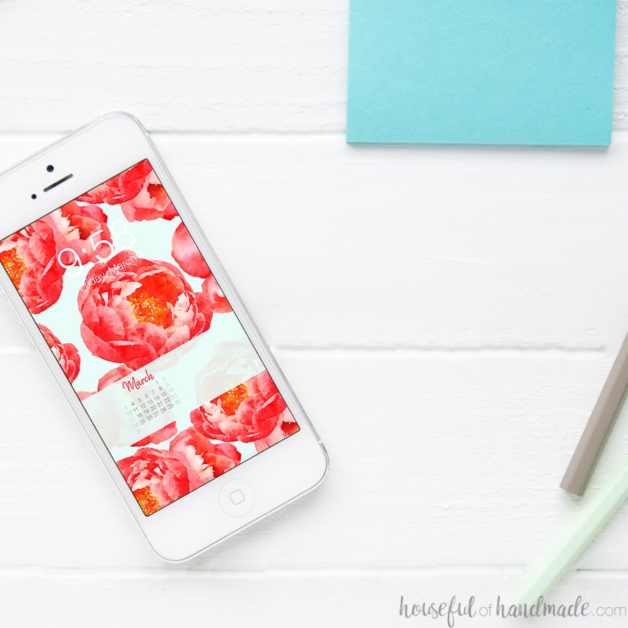 White iPhone with free digital backgrounds for March on the screen.