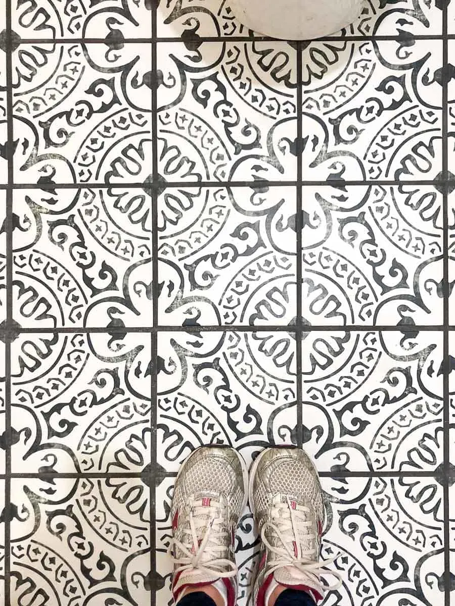 Black and white patterned tile with black grout in the rustic modern guest bathroom.