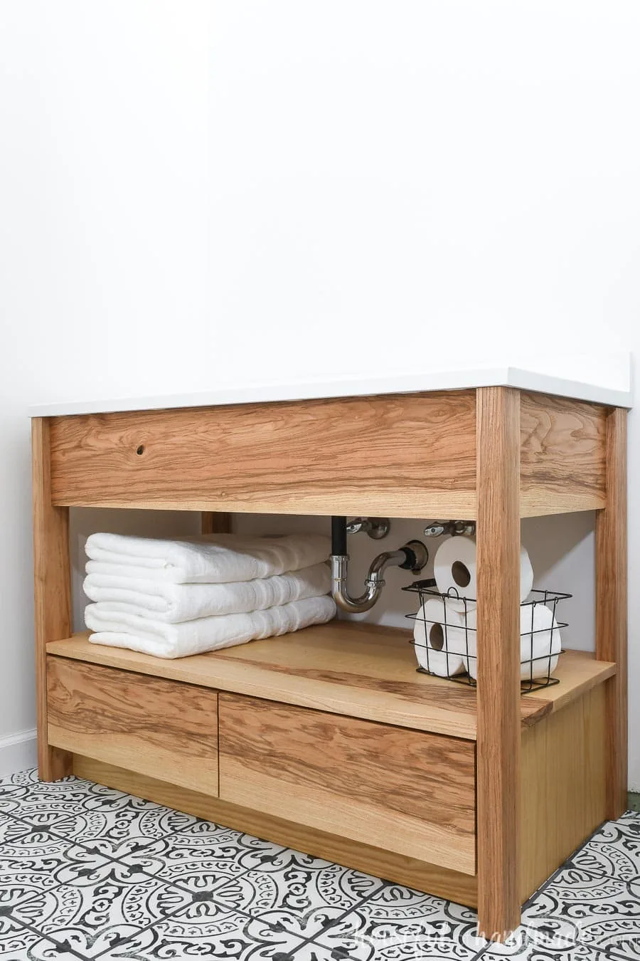 DIY 42" bathroom vanity made from ash wood with an open shelf for towels and bottom drawers. 