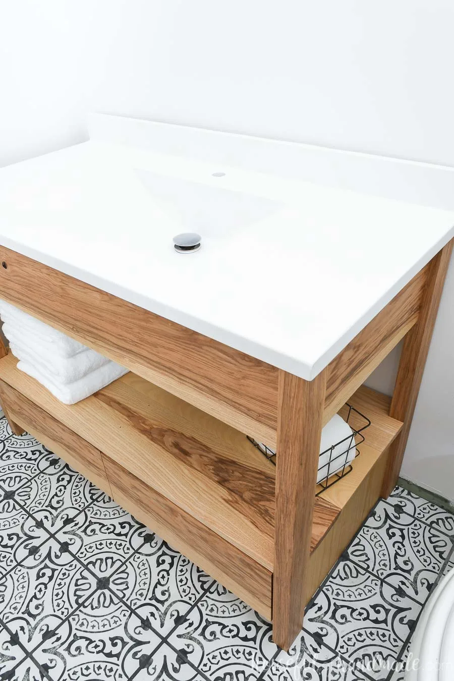 White one-piece vanity top with sink on top of a 42" bathroom vanity built from these free plans. 