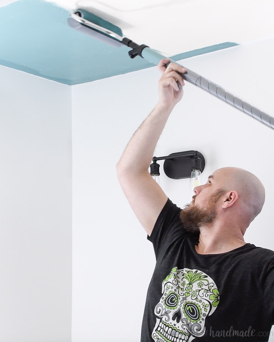 Rolling colorful paint on the ceiling with the HomeRight PaintStick EZ Twist. 