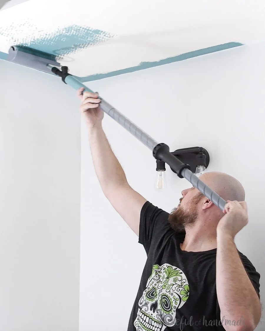 Priming the PaintStick roller as you start painting the ceiling the easy way. 