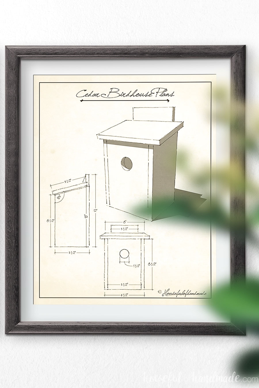 Cedar birdhouse plans art in a frame on the wall.