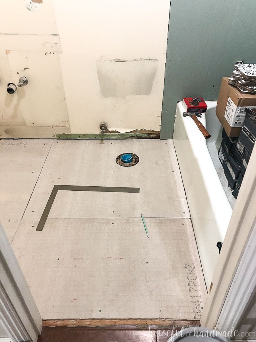 Blank floor of the bathroom before setting out floor tiles for the bathroom tile installation.