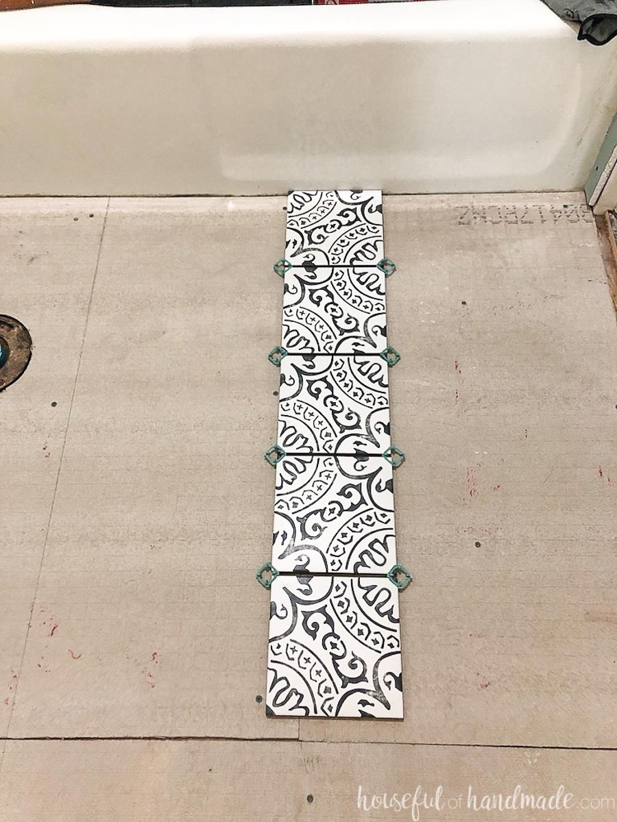 Row of tiles in a dry layout of patterned floor tiles before installing them. 