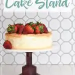 DIY cake stand made from hardwood and acrylic with a strawberry cake on top and words on it.