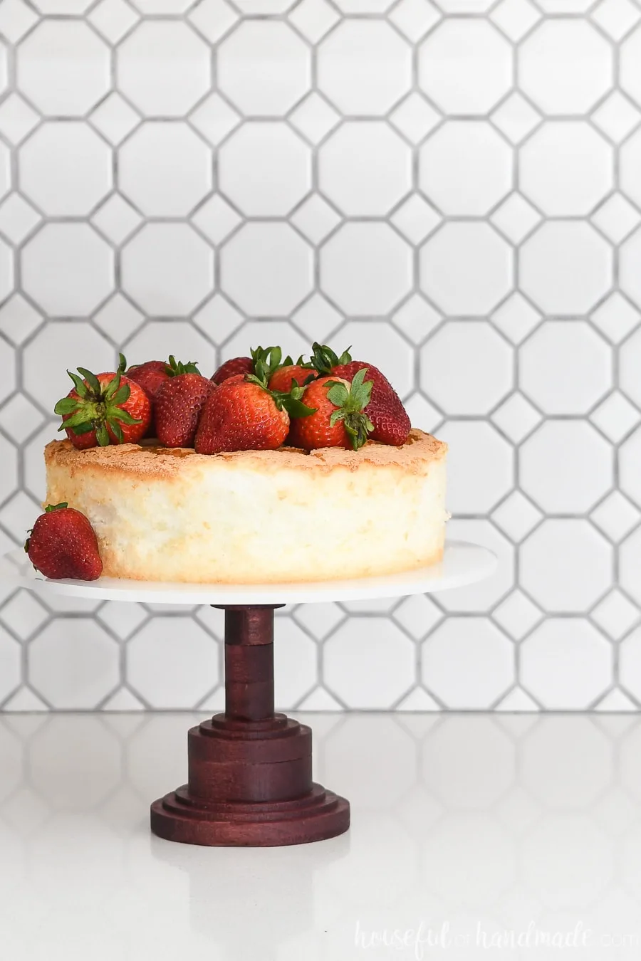 DIY cake stand made with a Purple Heart base and acrylic top with an angel food cake and strawberries on top.