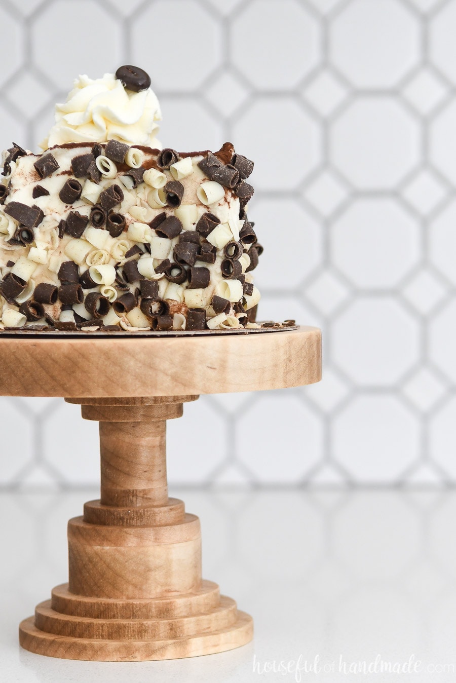 Small wooden cake stand made from Tiger Maple with a piece of Tiramisu on it. 