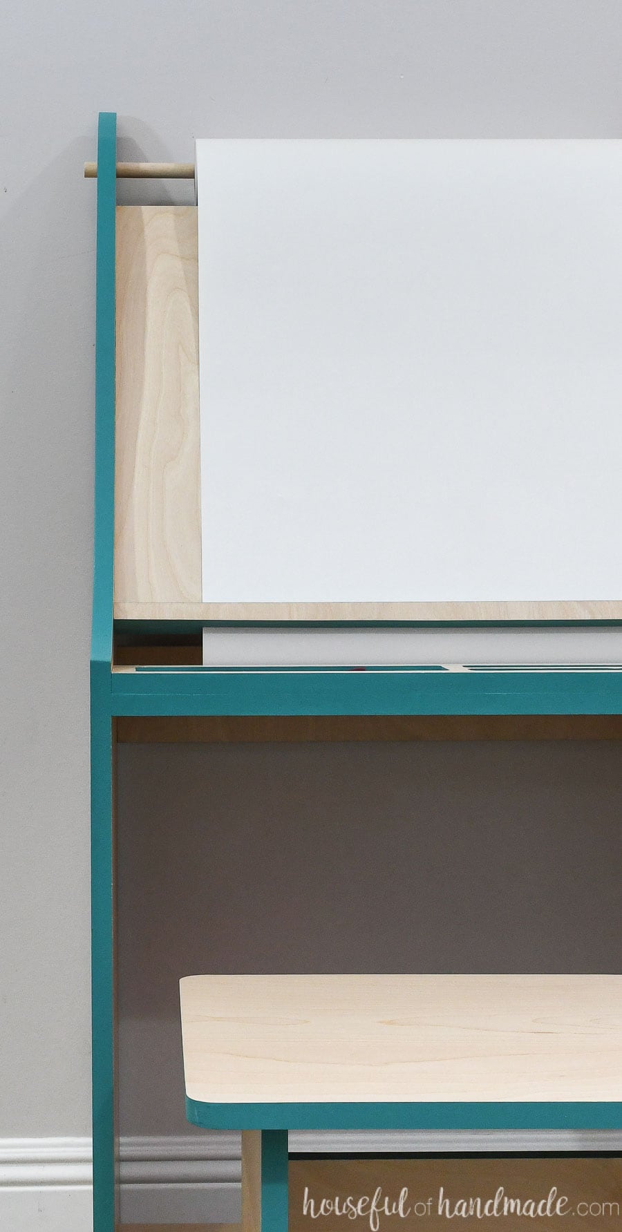 Straight on view of the kids easel made from one sheet of plywood with the edges painted turquoise. 