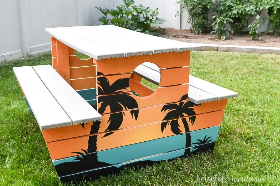 Kids wooden picnic table restored and painted with a tropical design. 